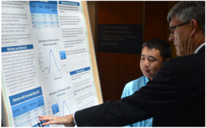 Yia presents his poster on NIR to an audience